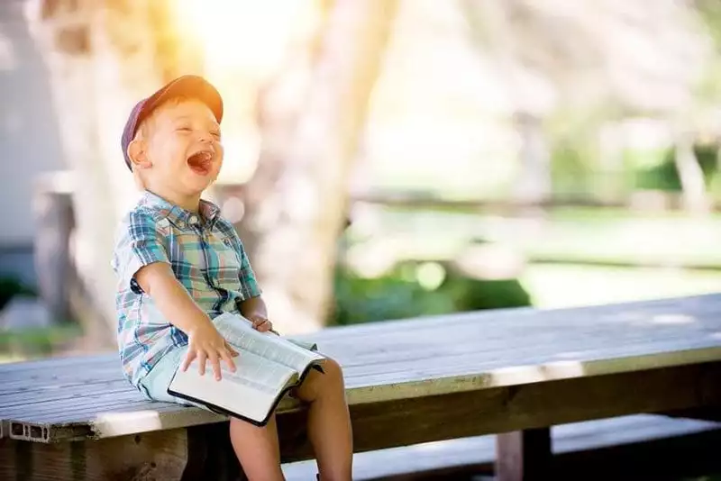 Laughing child and book