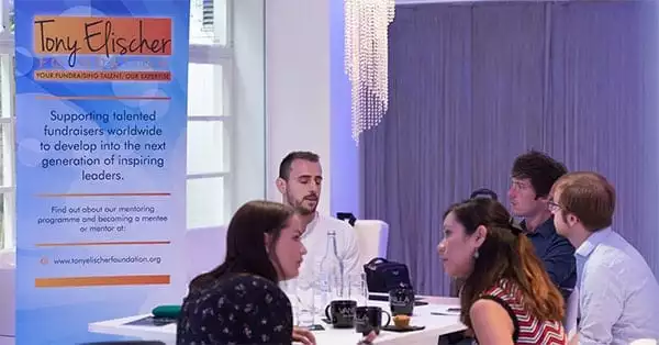 Tony Elischer Foundation mentees around a table