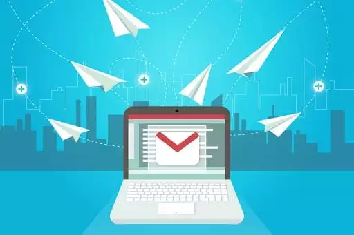 Emails flying like paper aeroplanes from a laptop