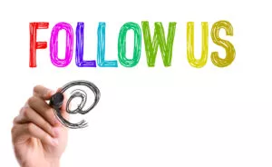 Hand with marker writing Follow Us on Instagram