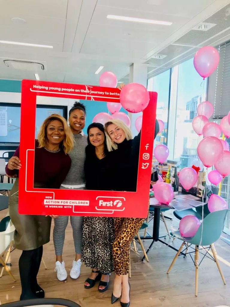 First Group staff pose in an Action for Children photoframe