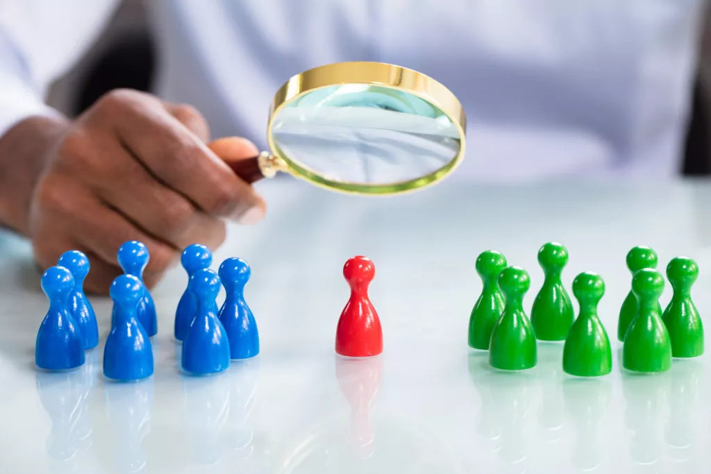 Segments - wooden toys suggesting individuals under a magnifying glass
