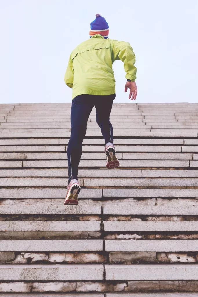 Man running up steps in running gear - unsplash.com