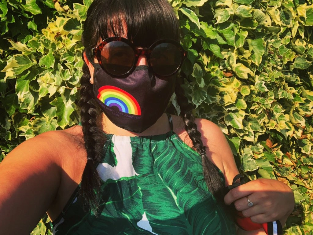 Woman wearing face mask with rainbow decoration