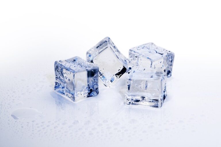 Four ice cubes next to each other, against a white background. Elements of the cubes have a blue colour in the light.