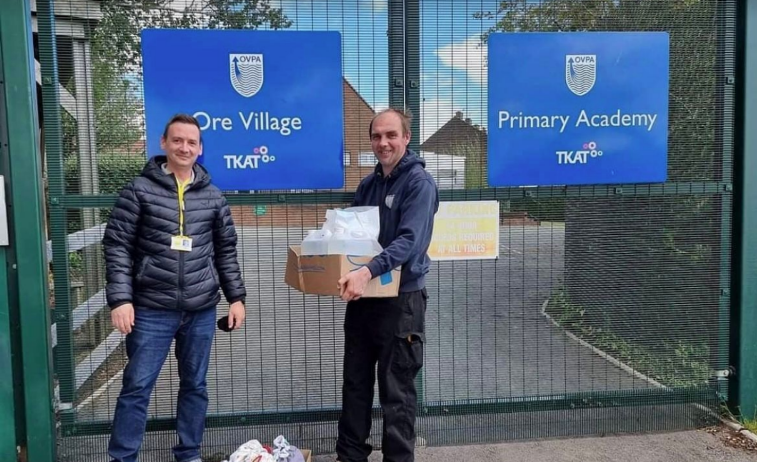 Staff from Proverb Skin deliver hand sanitiser to a school