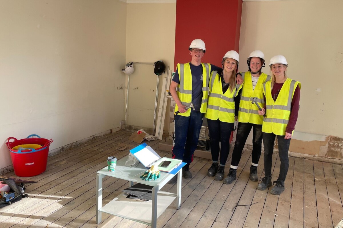A team of builders in yellow vests