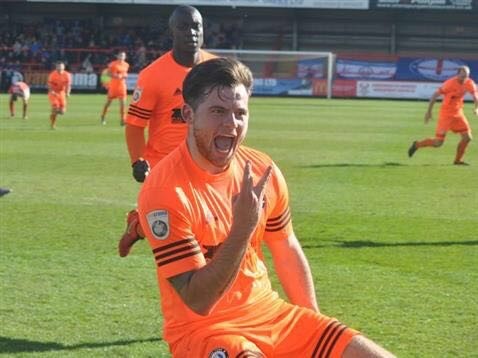 Jordan Sinnott on the pitch in orange kit