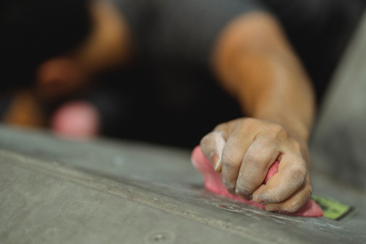 Hand holding on to a climbing wall. Photo: Pexels.com