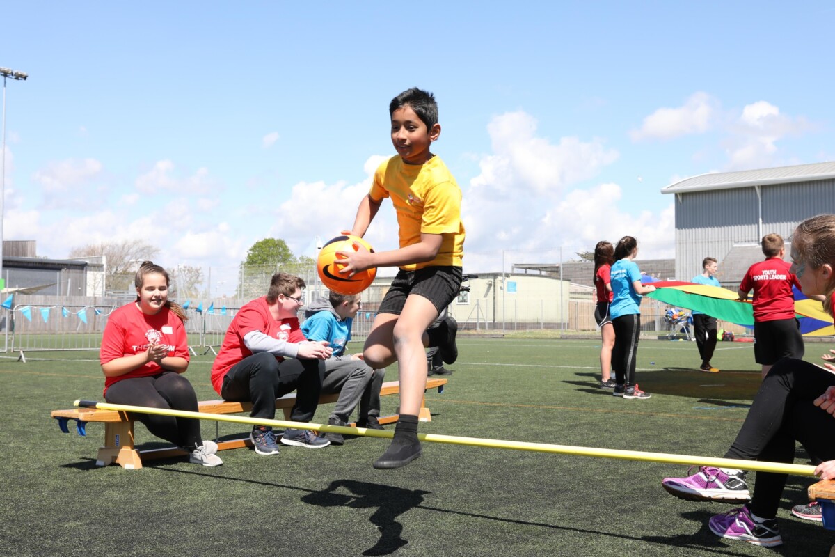 Children play football in a school playground