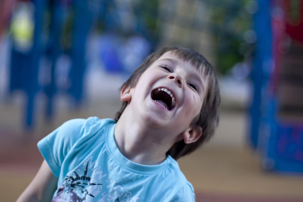 A boy laughs in a playground. By Poison Ivy on Pixabay