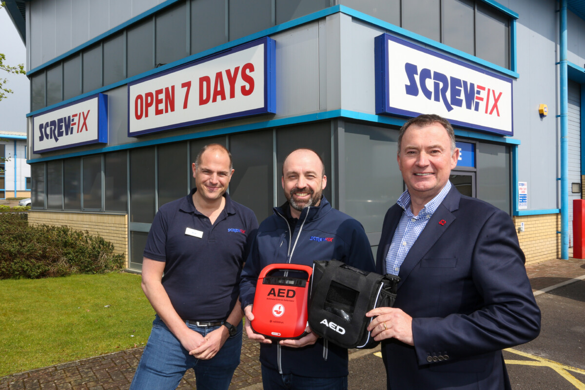 3 men in a Screwfix store in Southampton, with defribrillators that will be installed in a partnership with BHF
