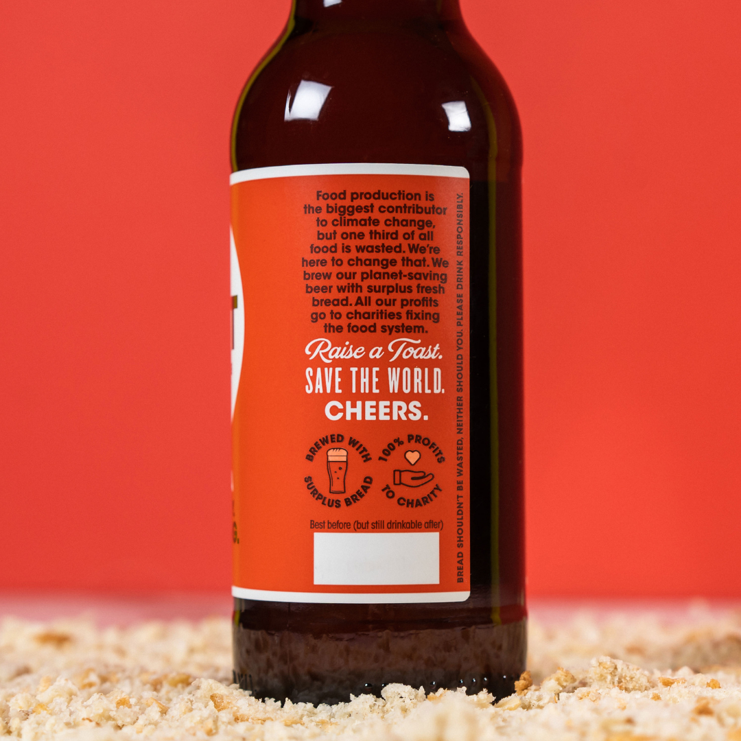 Label on the side of a Toast bottle, with the message 'Save the world. Cheers'.