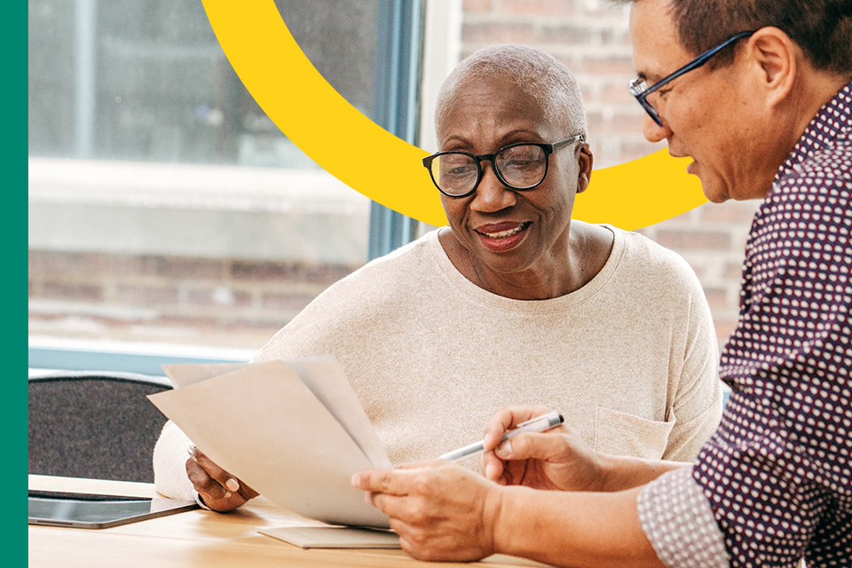 Man providing financial and tax advice to a woman at a desk.