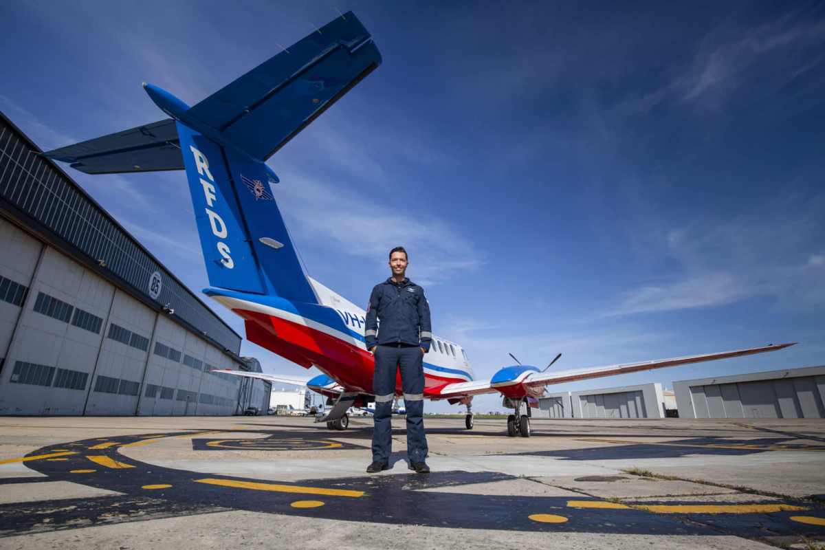 Red belly Royal Flying Doctor Service plane with pilot Sean and flight nurse at the Essendon hangar.