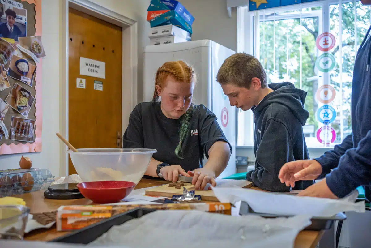 Aleea-Mae and Alex from Thomasson Memorial School making cookies for their Skill section.