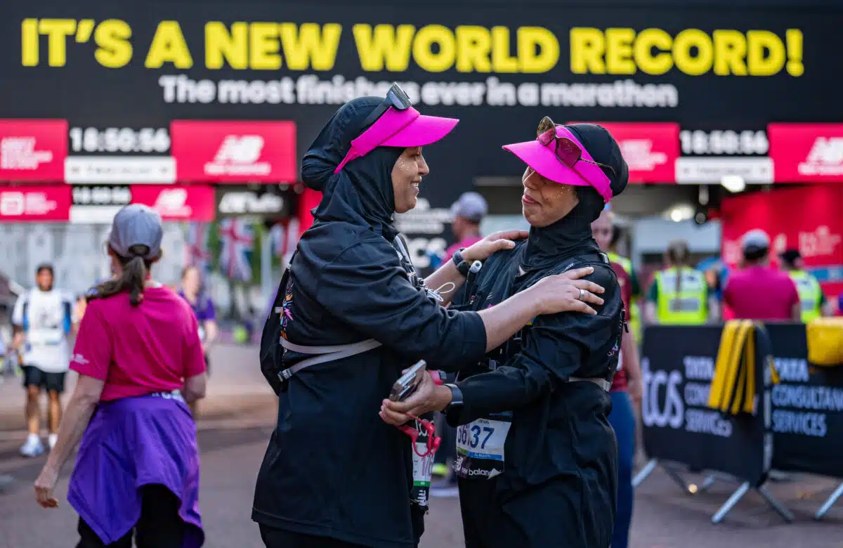 Runners celebrate after crossing the finish line together as a new world record for the most finishers ever in a marathon is completed during The TCS London Marathon on Sunday 27th April 2025.Photo: Andrew Baker for London Marathon Events