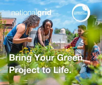 National Grid Community Matters Fund. Bring your green project to life. A community allotment with three people gathered around vegetables growing.