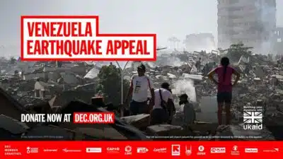 Venezueal Earthquake appeal campaign by DEC, with link to dec.org.uk. Black and white image of people standing in front of destroyed building.